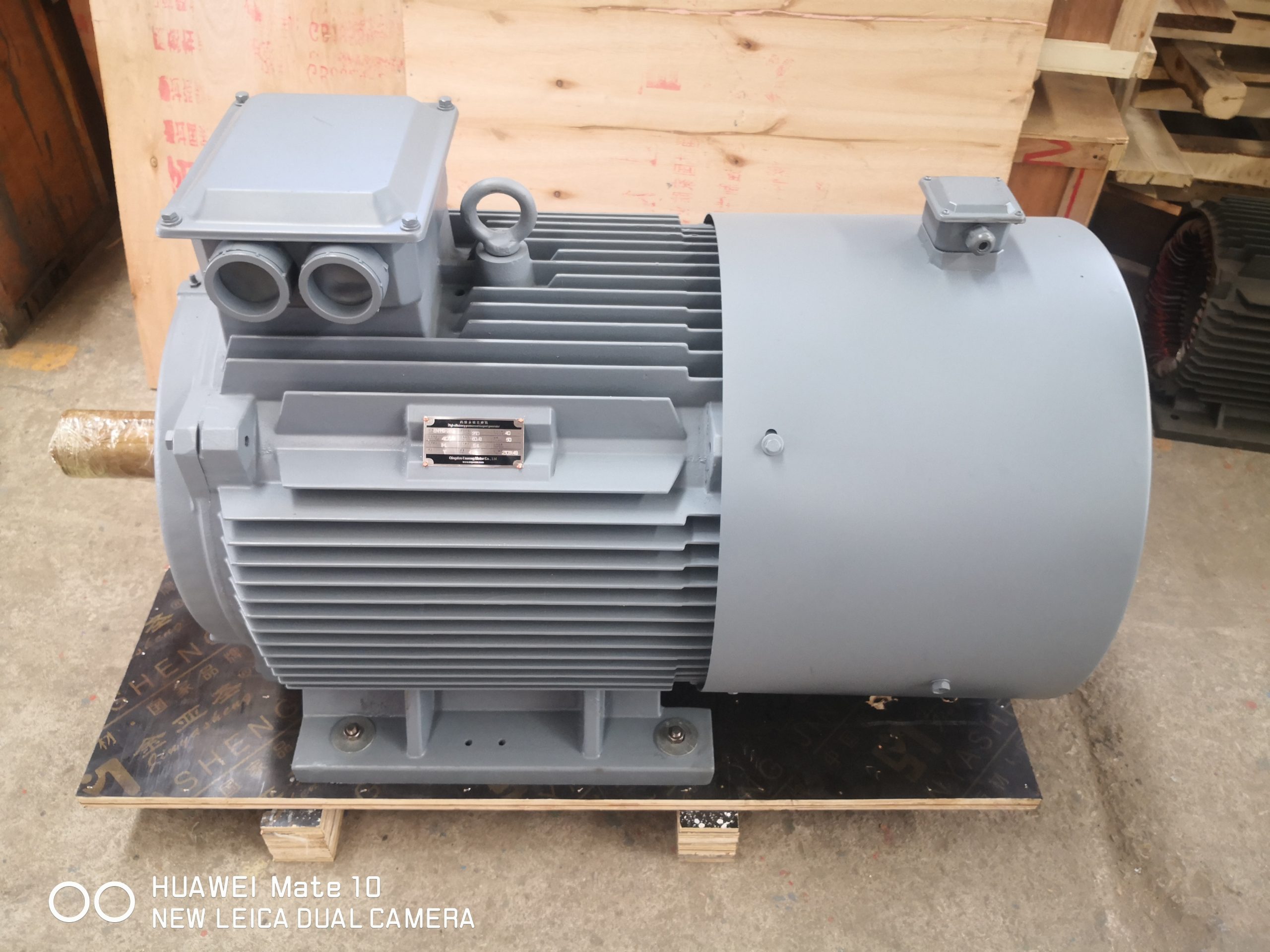 White industrial motor photographed on a workshop pallet